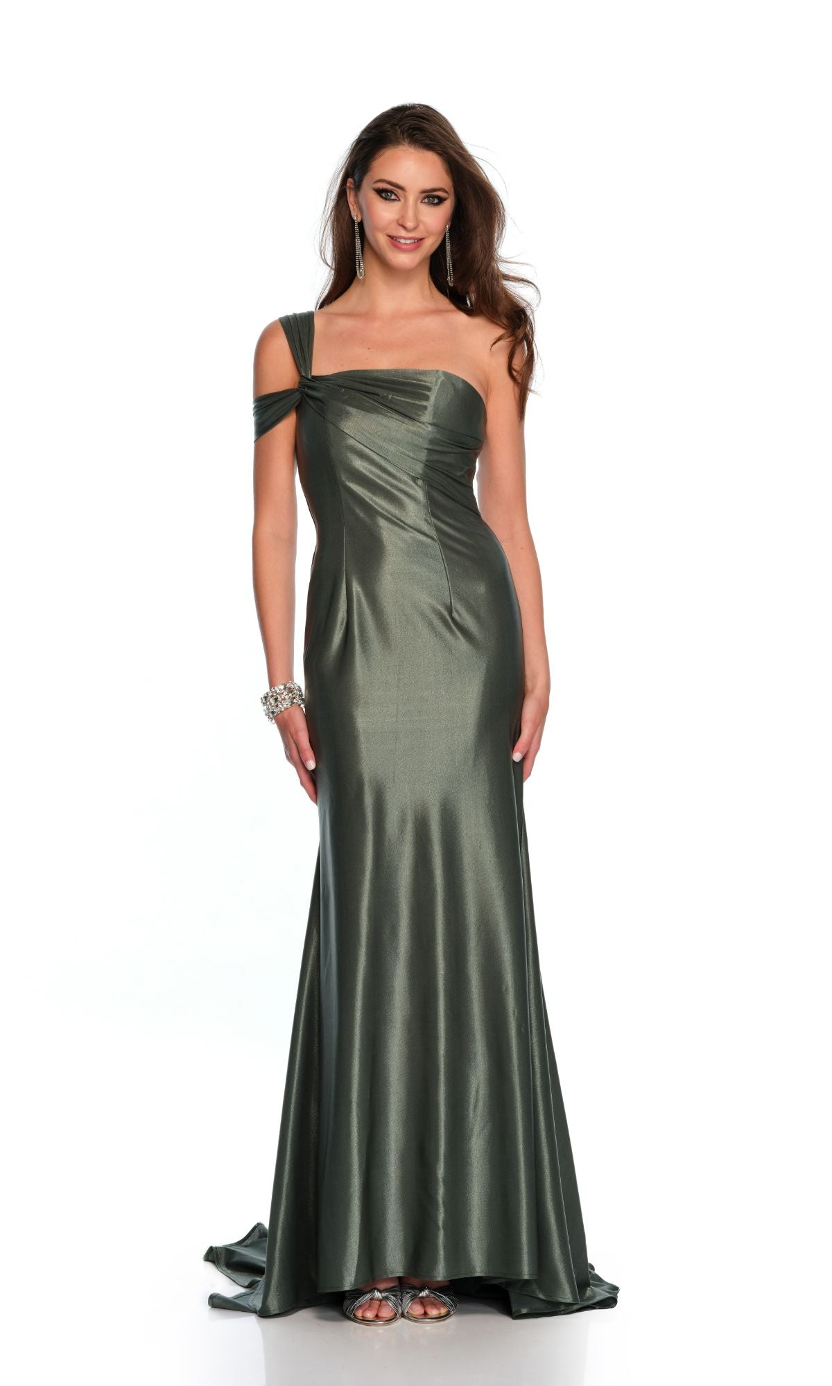A woman models the Long Formal Dress 11486 by Dave and Johnny—a metallic green, floor-length one-shoulder gown with draped detailing—paired with silver heels and jewelry, against a plain white background.